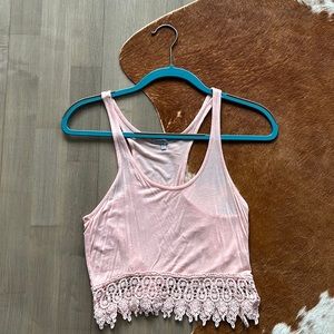 XS Charlotte Russe blush crop top with lace embellishment on the bottom.